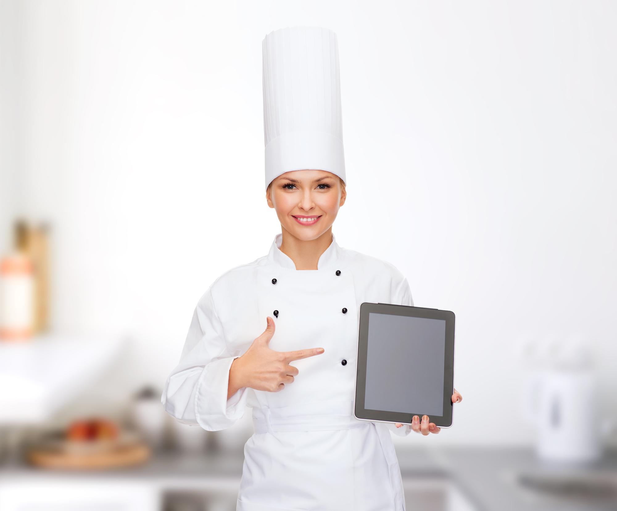 Chef teaching via tablet in a modern kitchen